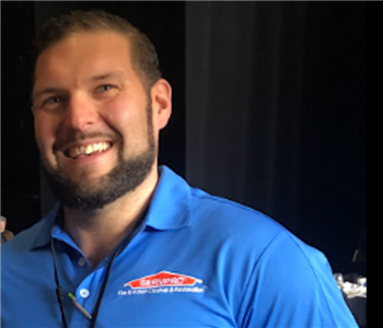 Male employee posing in a blue servpro shirt